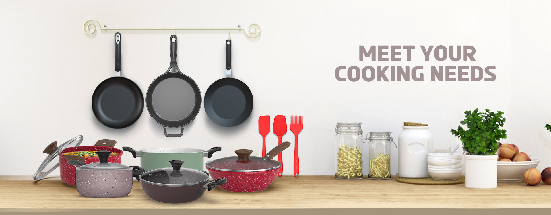 Kitchenware including pots, pans, and utensils on a wooden surface with a white background.